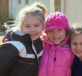 Three female Camelot students outside on a fall day